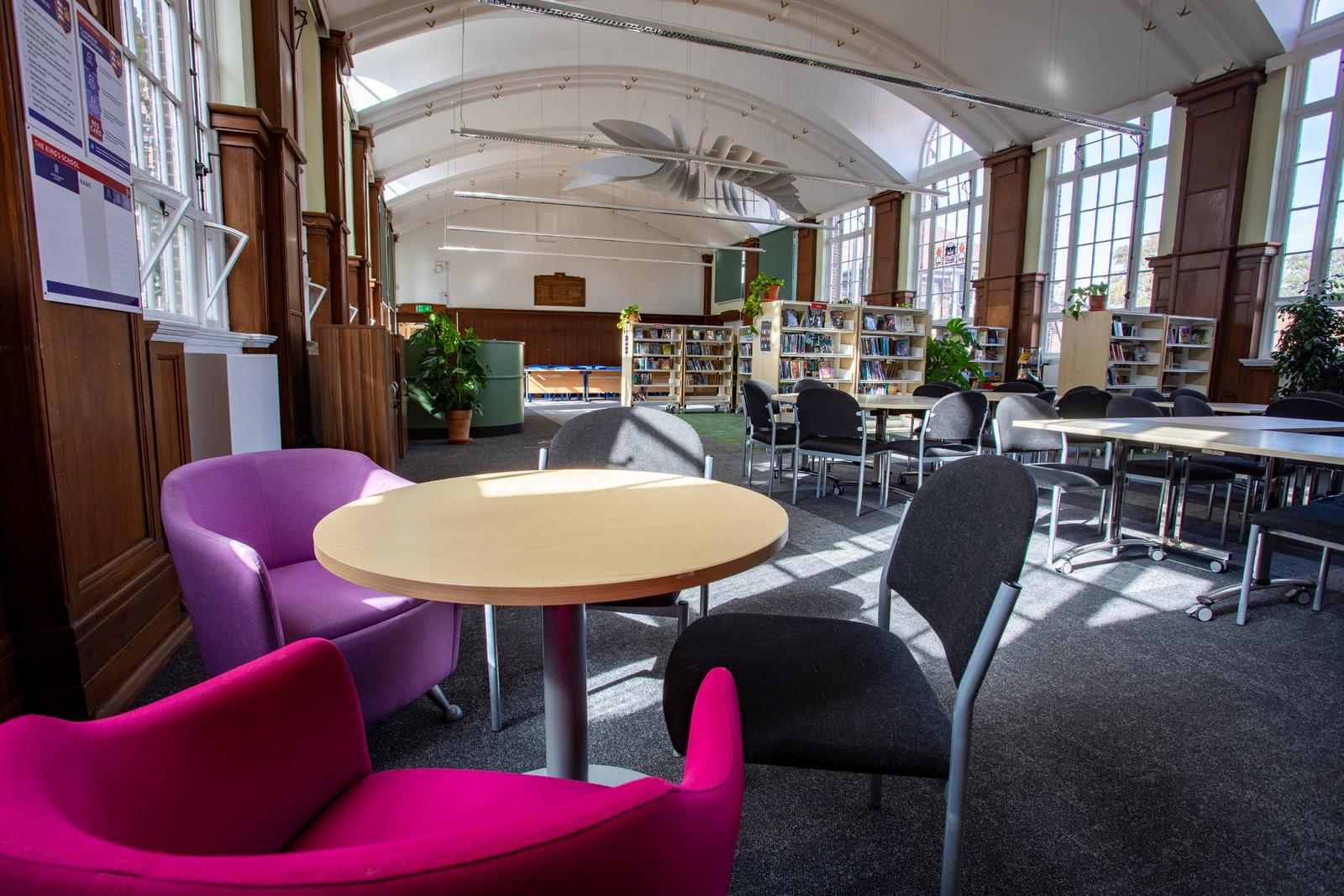 Library breakout area with pink and purple seating