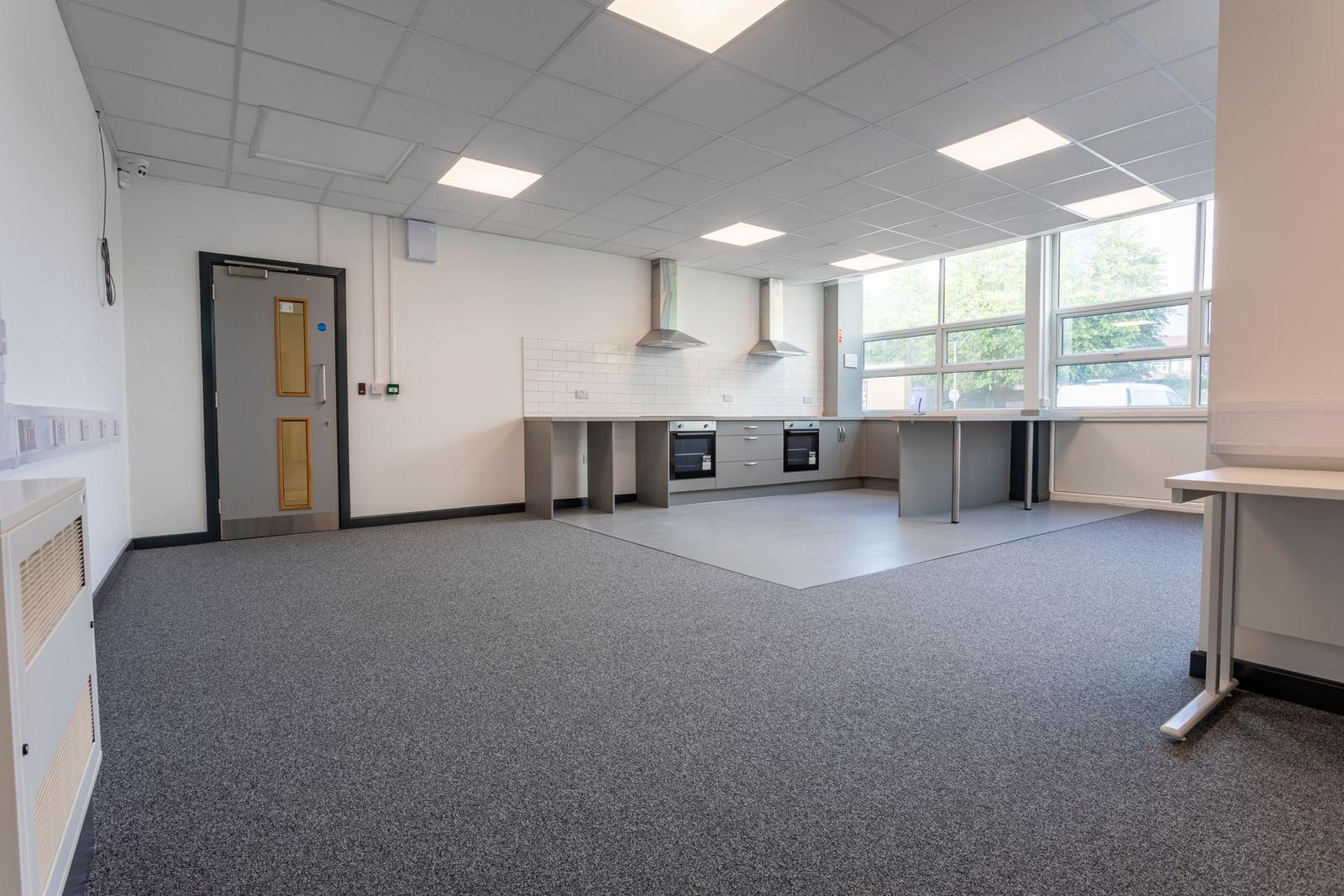 After: bright refurbished resource room with new ceiling, lighting, flooring and kitchen area