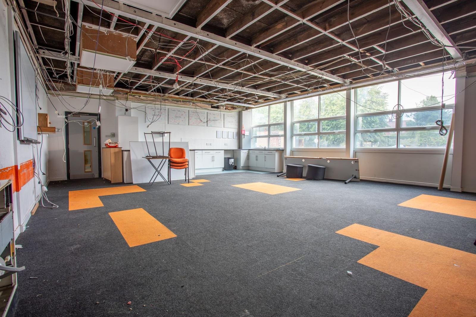 Before: resource room stripped back with ceiling grid exposed