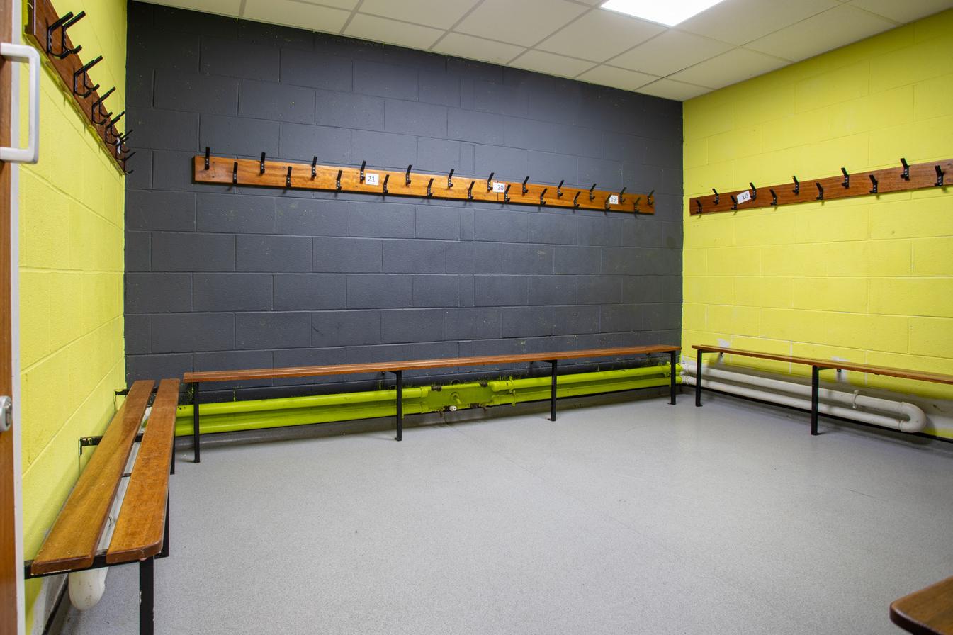 Before: changing room with yellow and dark painted walls